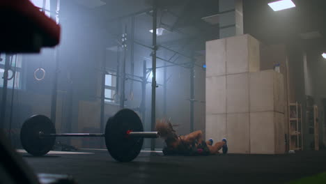 strong-woman-during-workout-workout-keeps-burpee-with-heavy-dumbbells-doing-push-UPS-and-jumping-out-in-the-gym
